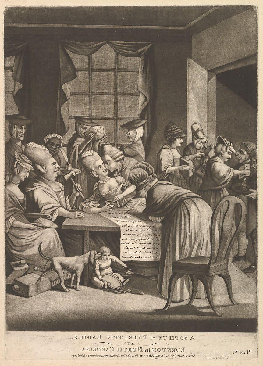 A group of well dressed ladies gathered around a table. A baby sits under the table next to a dog.